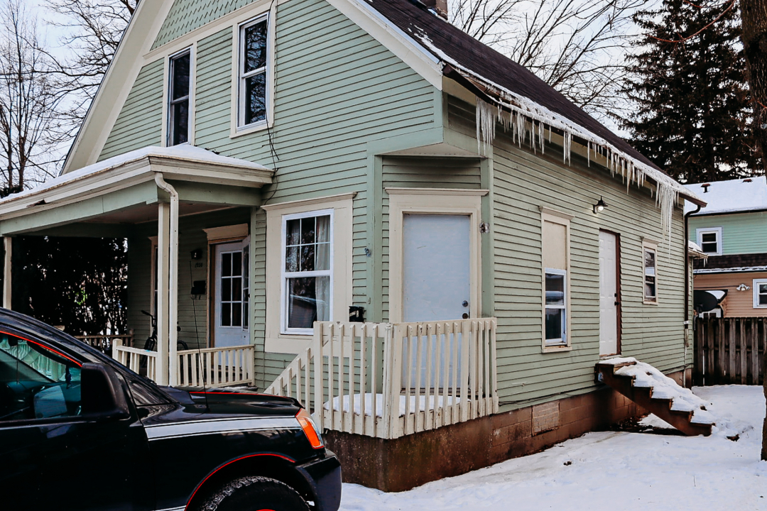 a view of a house with a wooden deck