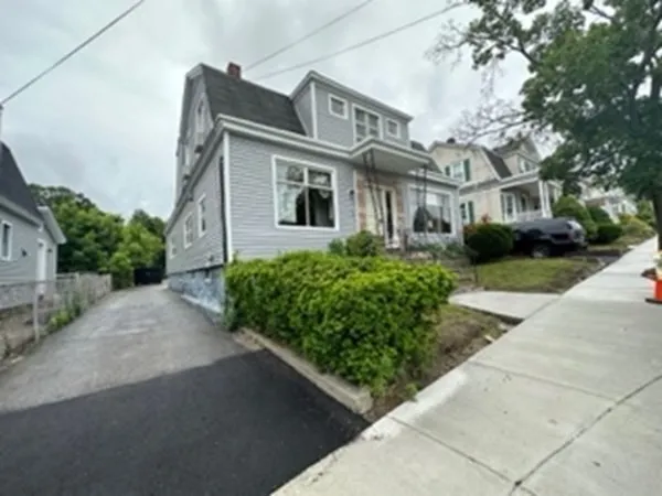 a front view of a house with a garden