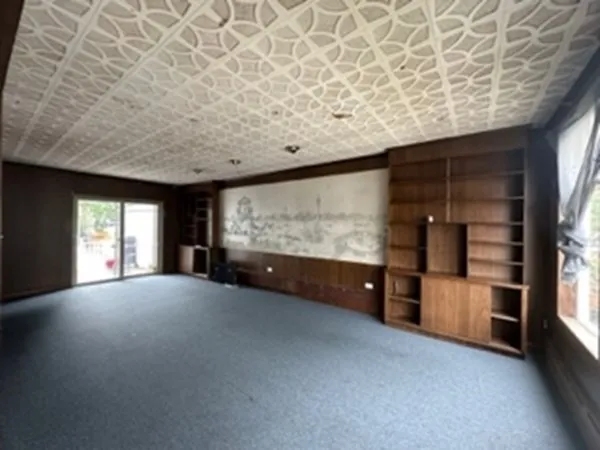 a view of an empty room and a window