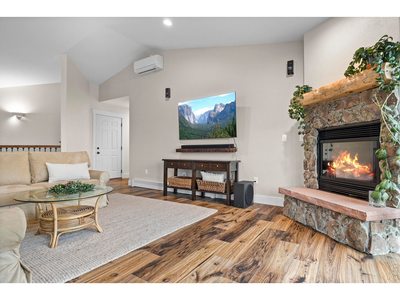 8609 Ranch Road Loveland, CO 80537 - Photo 7 of 44 Gas Fireplace with Stone Surround and Wood Beam Mantel and Stone Hearth