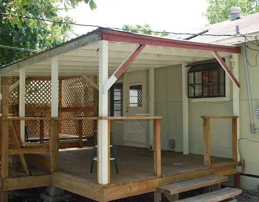a front view of house with a garden