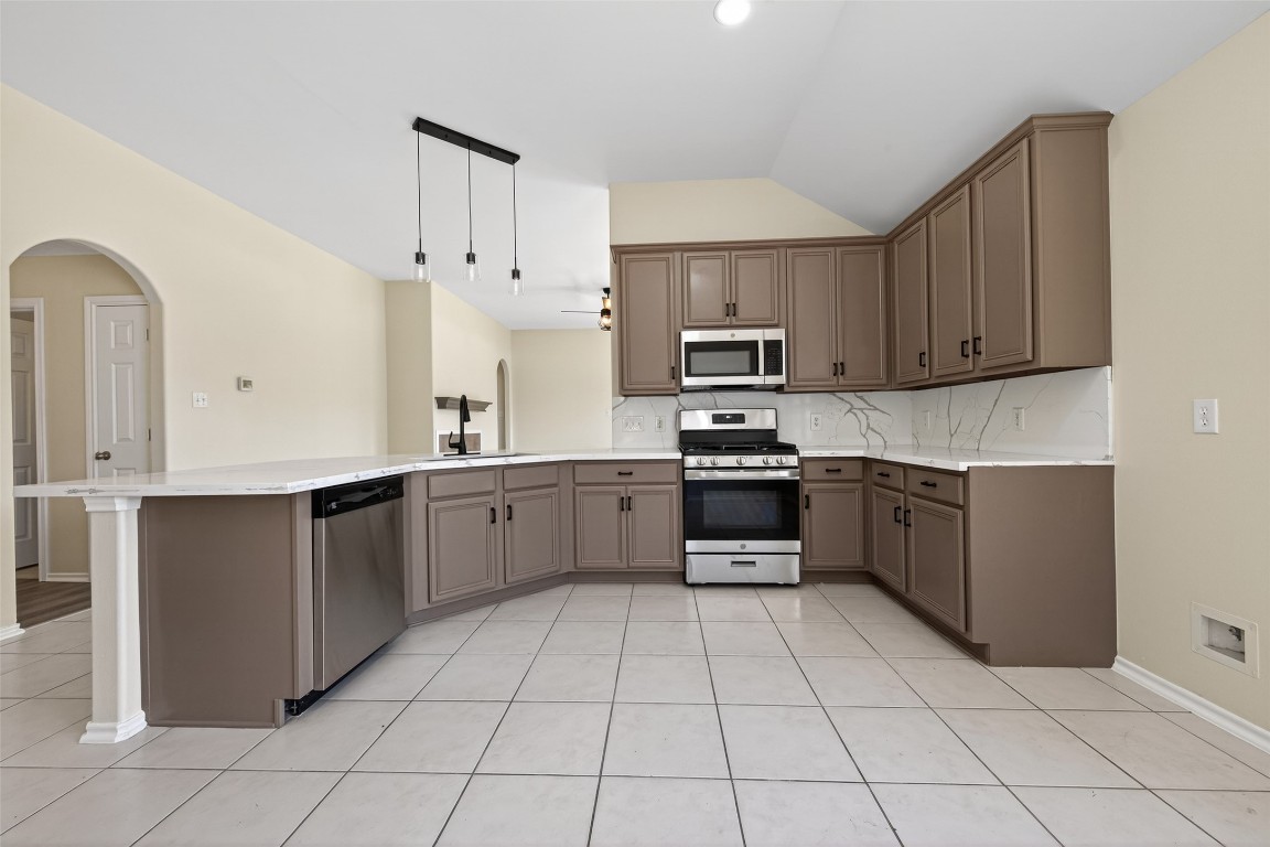 19902 Chaste Tree Lane Humble, TX 77338 - Photo 11 of 43 a large kitchen with stainless steel appliances granite countertop a stove a sink dishwasher and a refrigerator