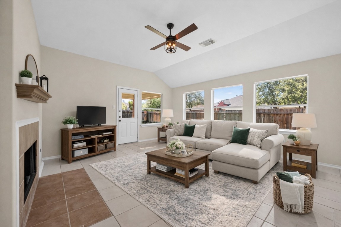19902 Chaste Tree Lane Humble, TX 77338 - Photo 17 of 43 a living room with furniture a fireplace and a flat screen tv