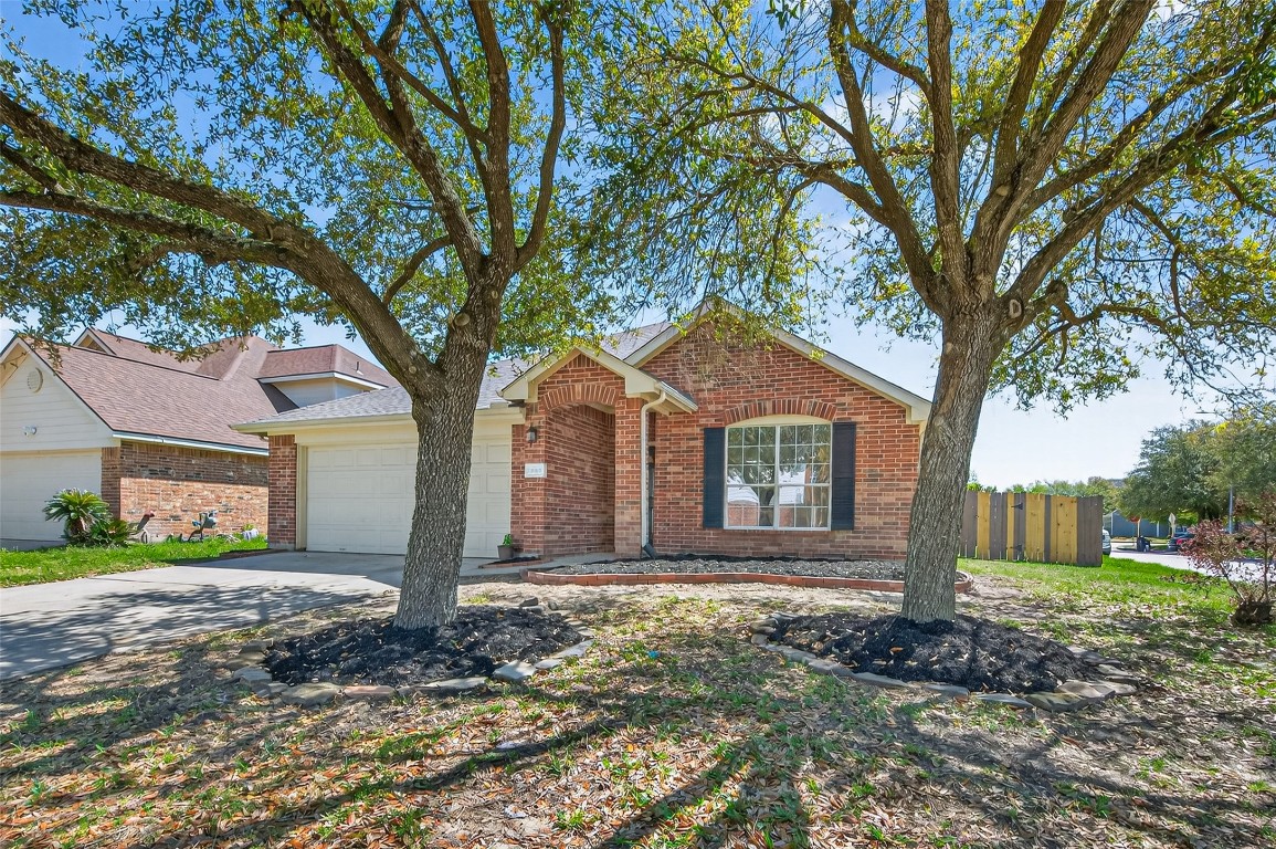 19902 Chaste Tree Lane Humble, TX 77338 - Photo 2 of 43 a front view of a house with garden