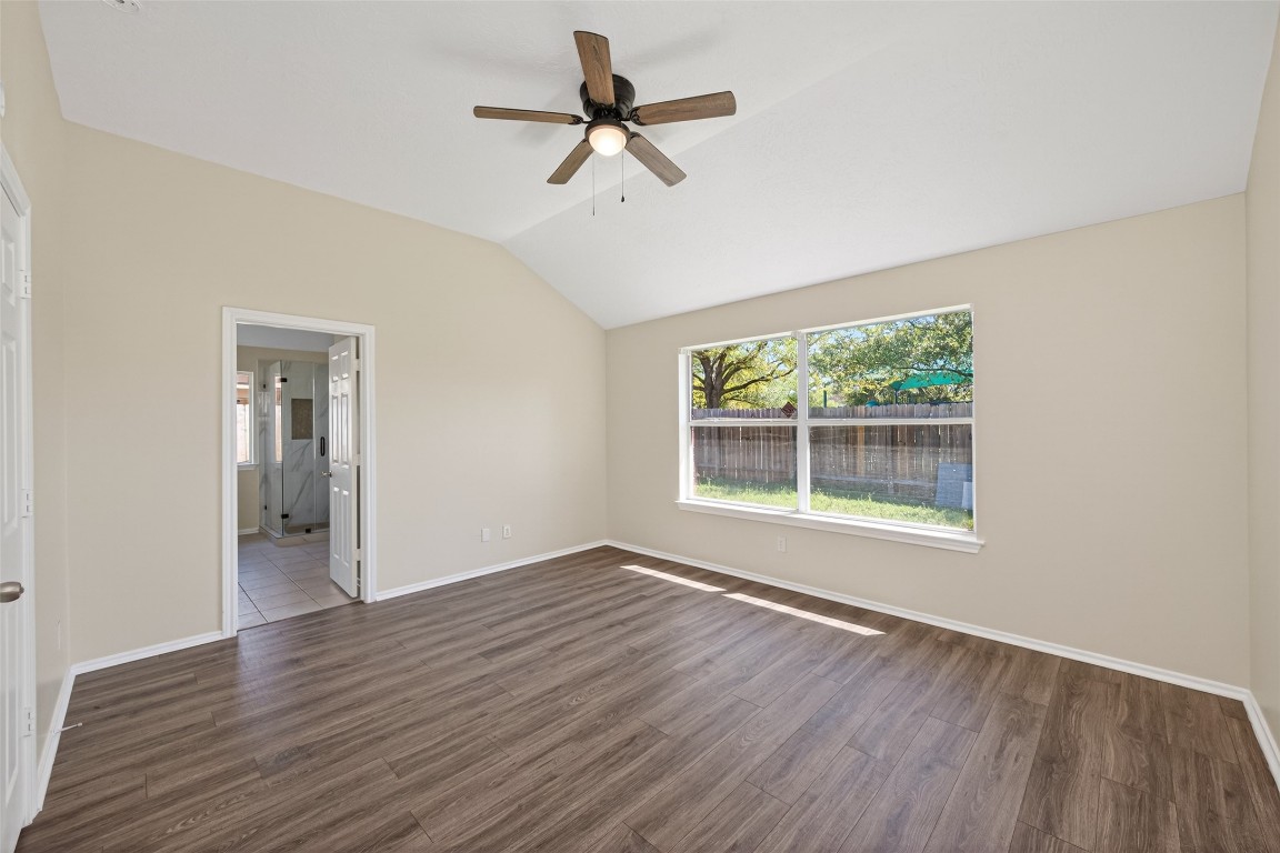 19902 Chaste Tree Lane Humble, TX 77338 - Photo 22 of 43 an empty room with wooden floor fan and windows