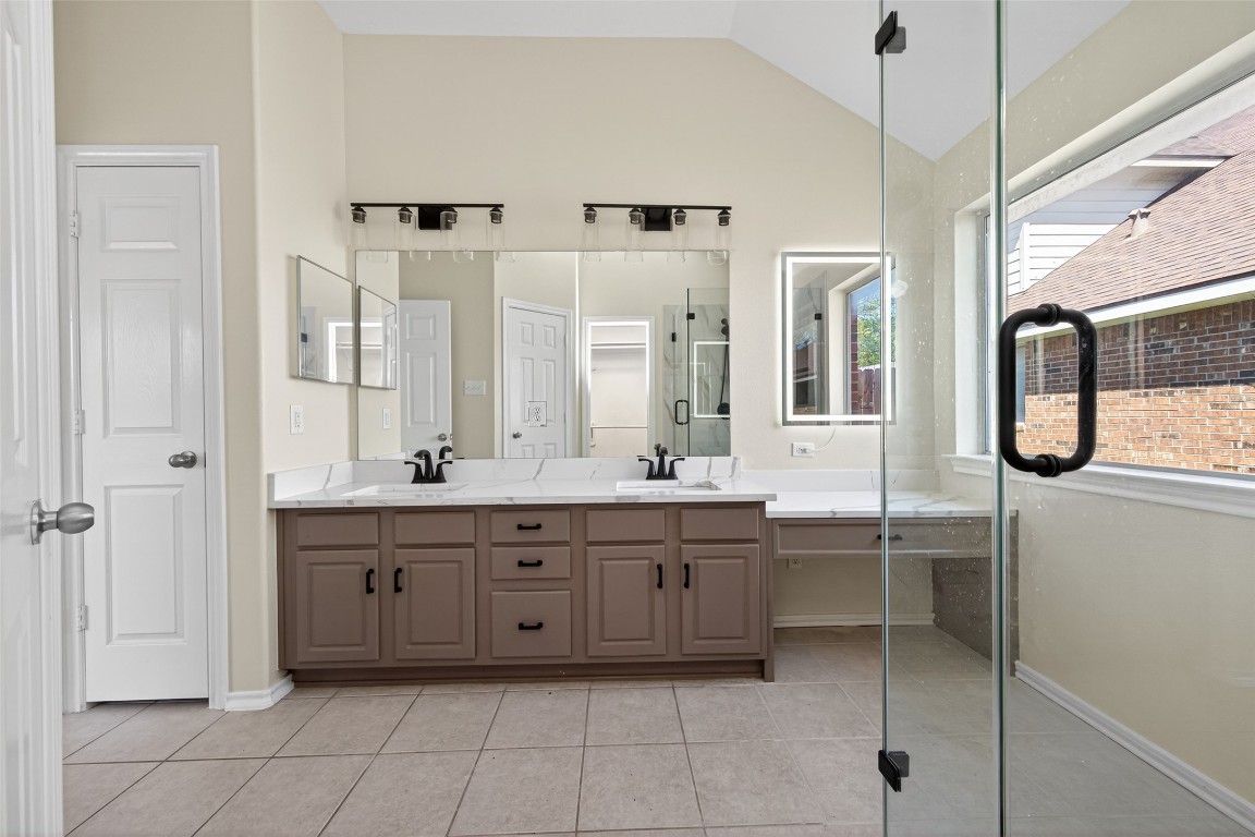 19902 Chaste Tree Lane Humble, TX 77338 - Photo 23 of 43 a spacious bathroom with a double vanity sink a mirror and a bathtub