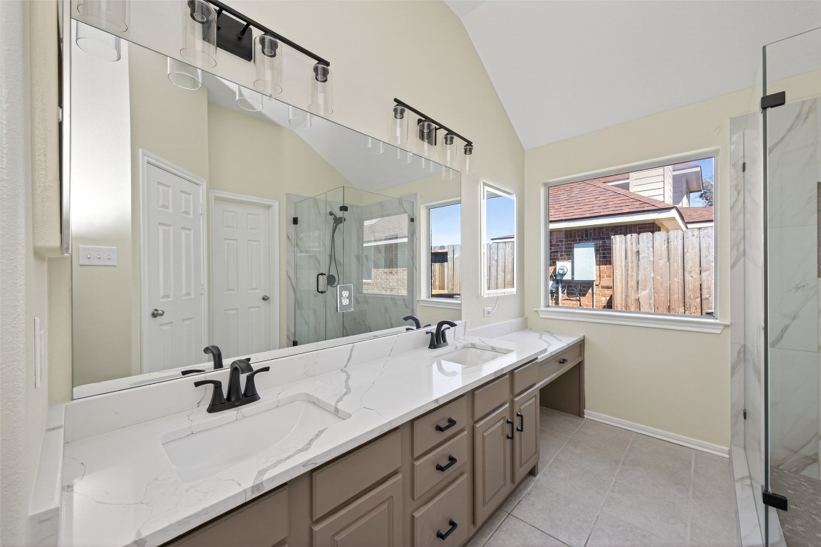 19902 Chaste Tree Lane Humble, TX 77338 - Photo 25 of 43 a bathroom with a sink double vanity granite tub shower and mirror