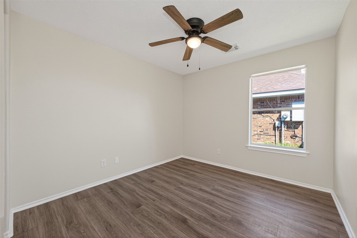 19902 Chaste Tree Lane Humble, TX 77338 - Photo 27 of 43 an empty room with wooden floor and windows