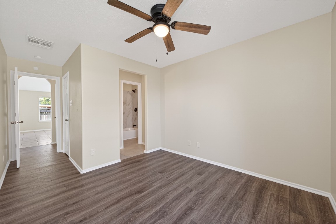 19902 Chaste Tree Lane Humble, TX 77338 - Photo 29 of 43 an empty room with wooden floor a ceiling fan and closet