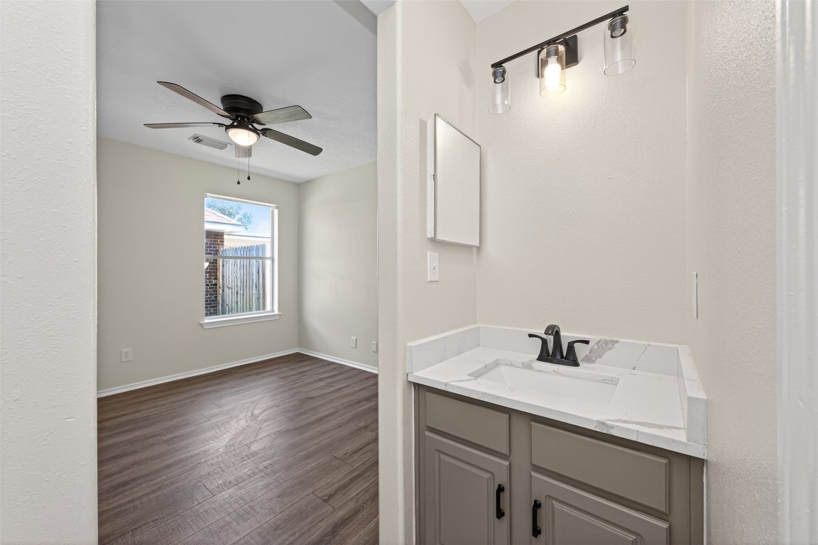 19902 Chaste Tree Lane Humble, TX 77338 - Photo 31 of 43 a bathroom with a sink a mirror and shower