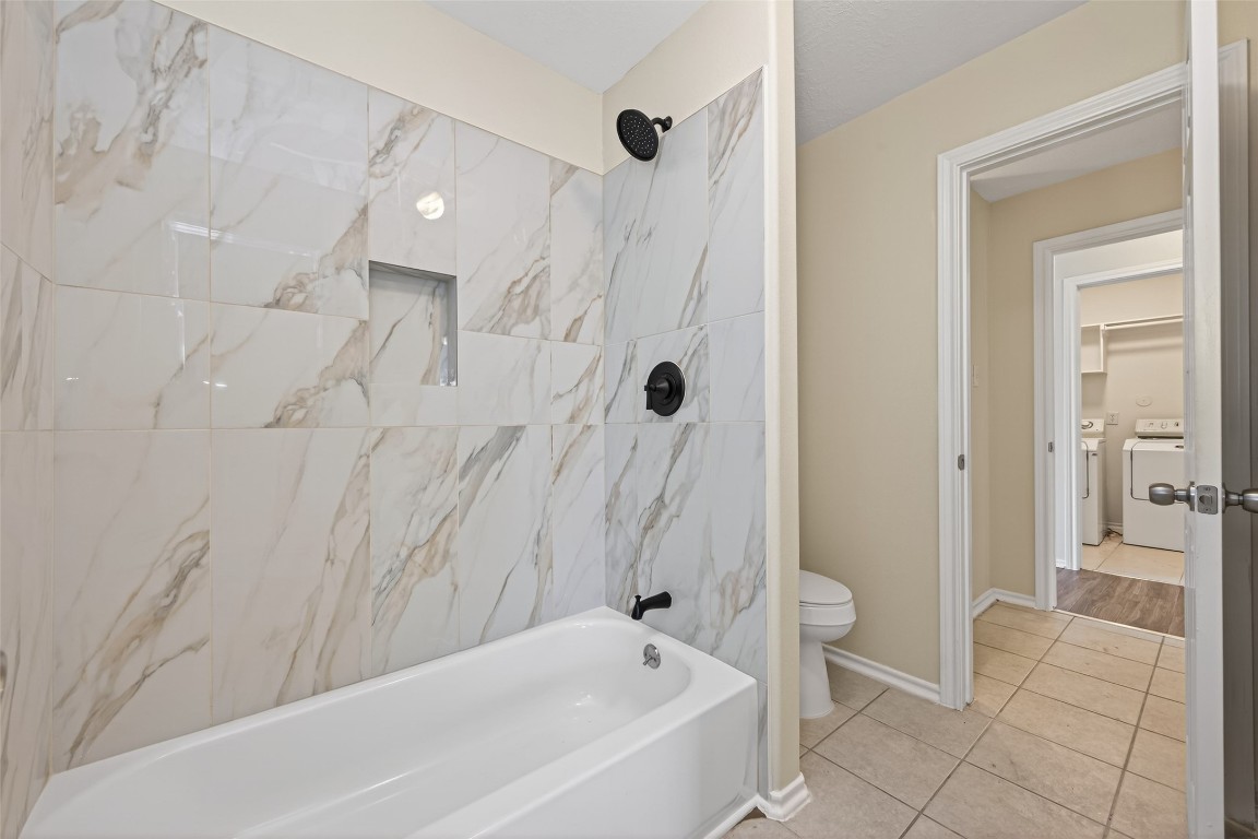 19902 Chaste Tree Lane Humble, TX 77338 - Photo 32 of 43 a bathroom with a bathtub and a shower