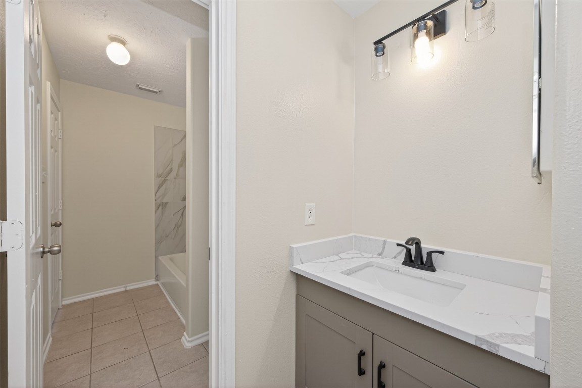 19902 Chaste Tree Lane Humble, TX 77338 - Photo 33 of 43 a bathroom with a sink and mirror
