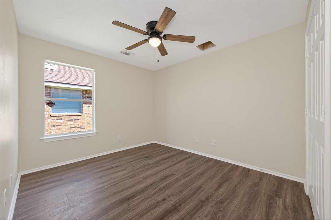 19902 Chaste Tree Lane Humble, TX 77338 - Photo 34 of 43 a view of a room with wooden floor and a ceiling fan