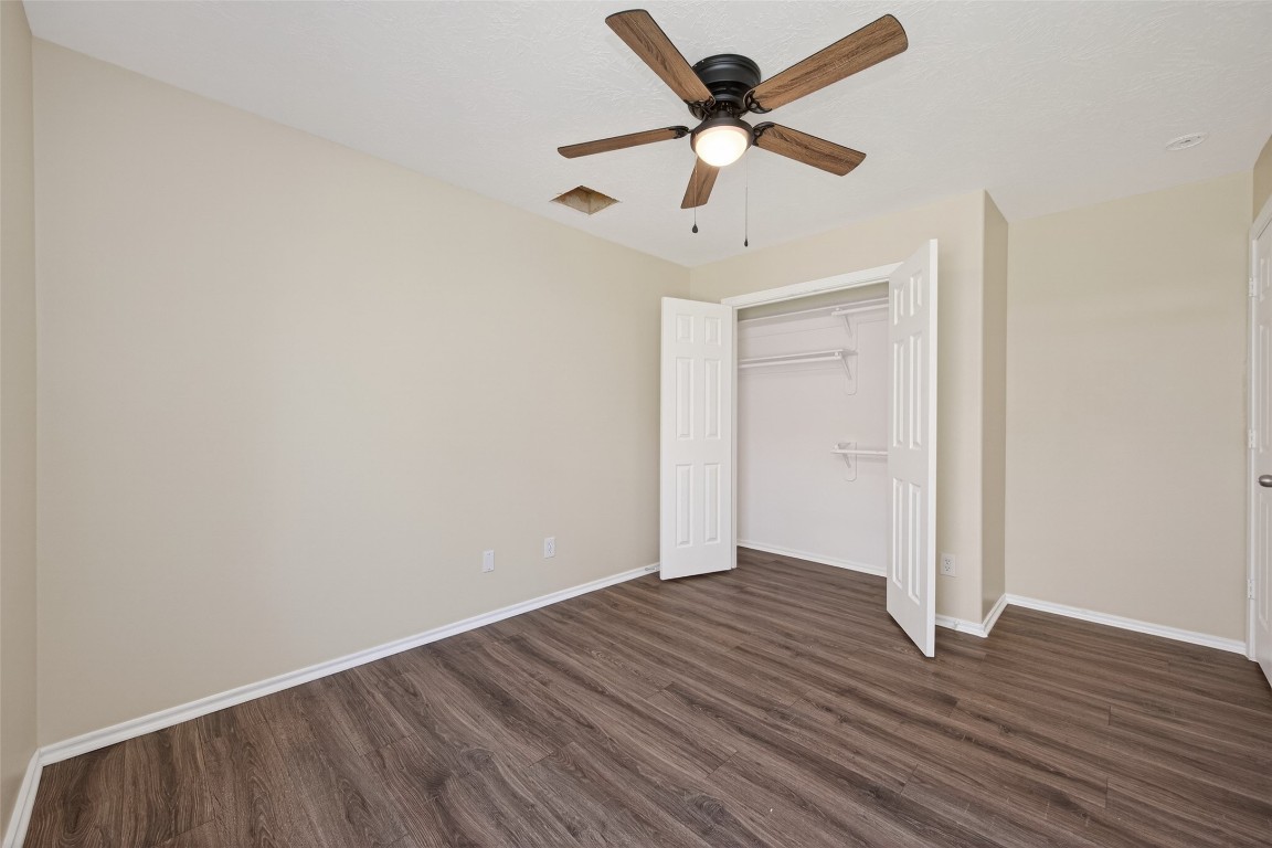 19902 Chaste Tree Lane Humble, TX 77338 - Photo 35 of 43 an empty room with wooden floor and a ceiling fan