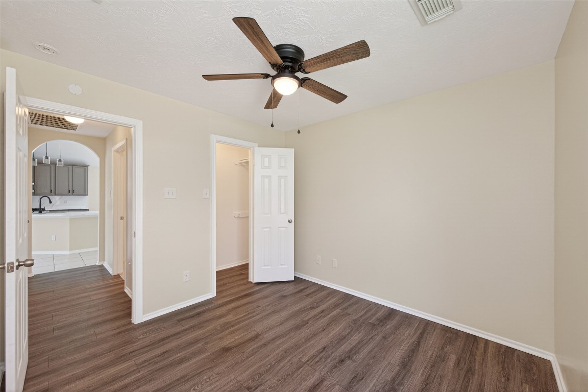 19902 Chaste Tree Lane Humble, TX 77338 - Photo 37 of 43 an empty room with wooden floor and a ceiling fan