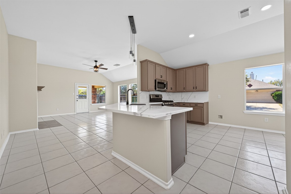 19902 Chaste Tree Lane Humble, TX 77338 - Photo 9 of 43 a kitchen with a sink cabinets and window