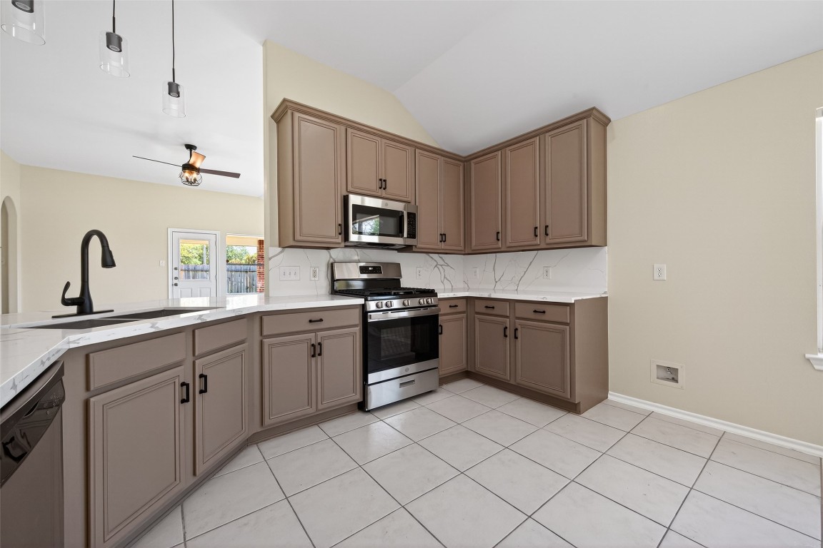 19902 Chaste Tree Lane Humble, TX 77338 - Photo 10 of 43 a kitchen with appliances a sink and cabinets