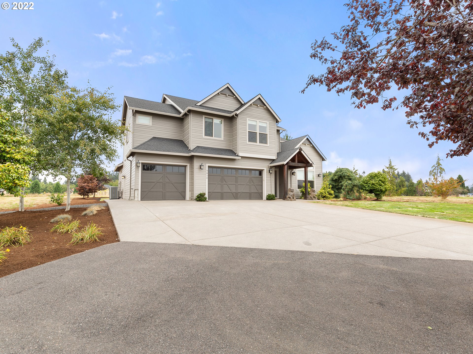 4820 Northwest 209th Street Ridgefield, WA 98642 - Photo 1 of 28 a front view of a house with a yard and garage