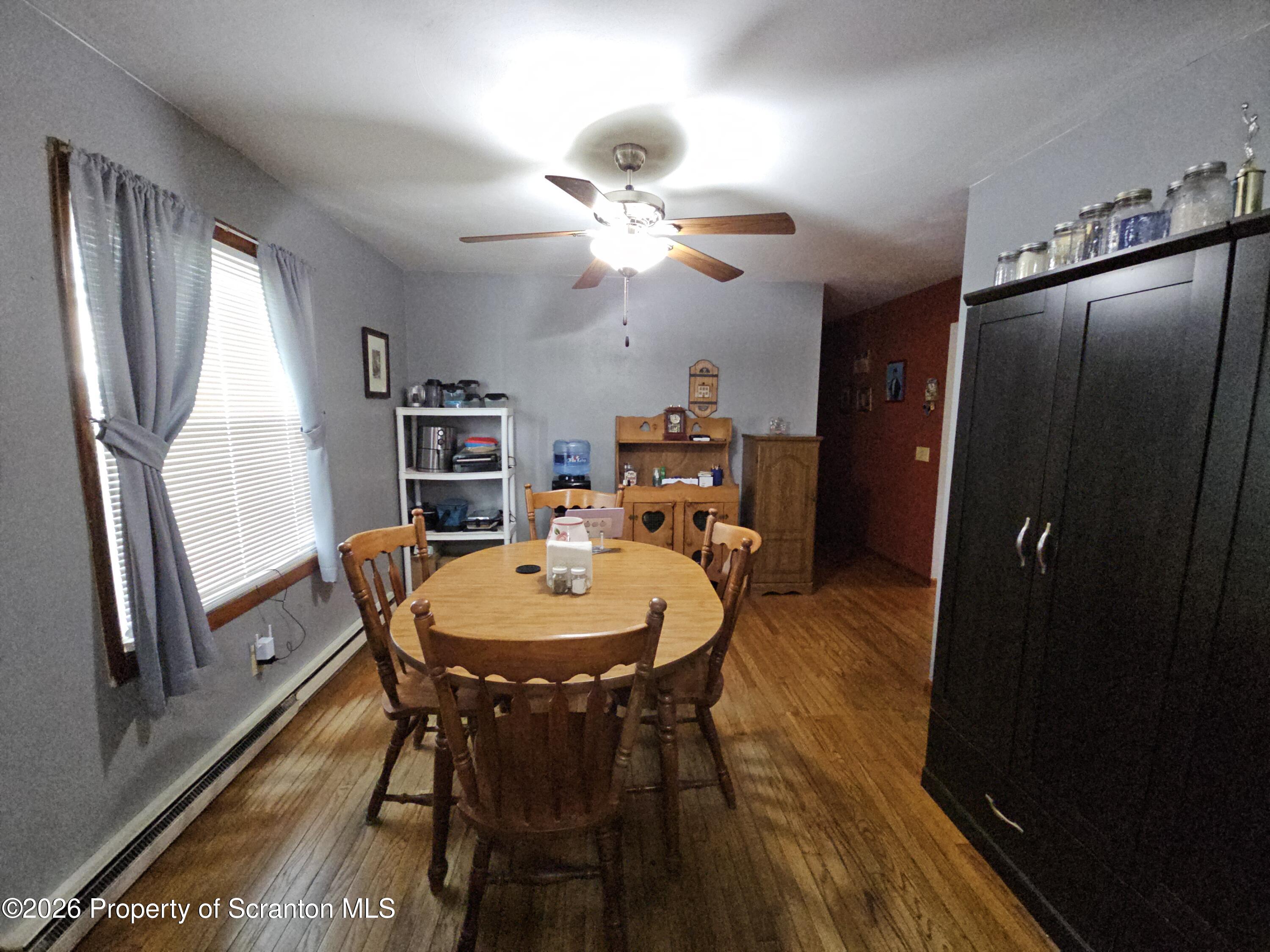 405 Baker Street Taylor, PA 18517 - Photo 11 of 36 a view of a dining room with furniture window and wooden floor