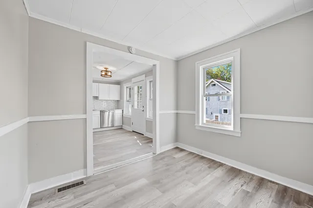 an empty room with windows and closet