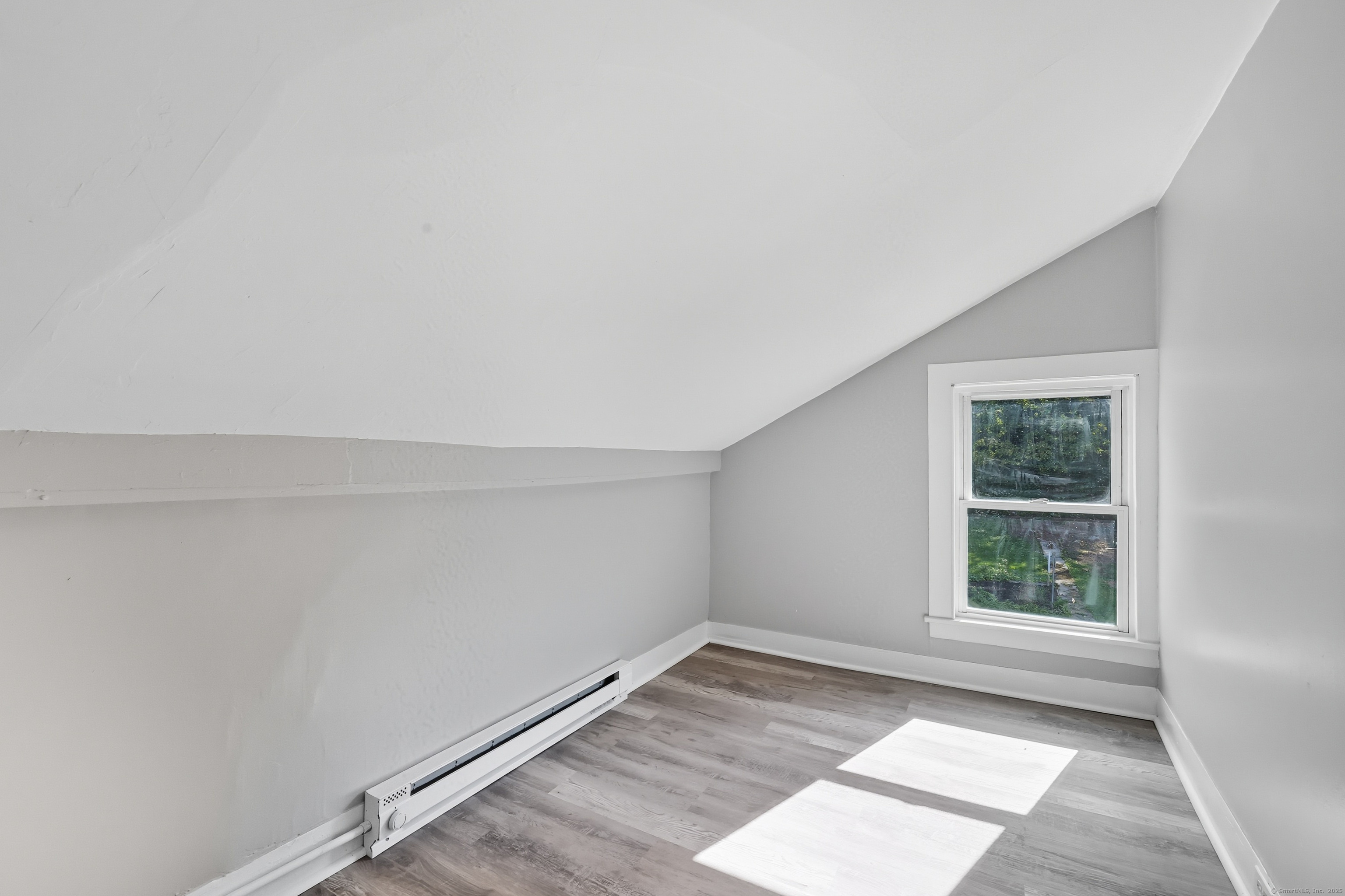 785 Main Street Plymouth, CT 06782 - Photo 16 of 30 an empty room with wooden floor and windows