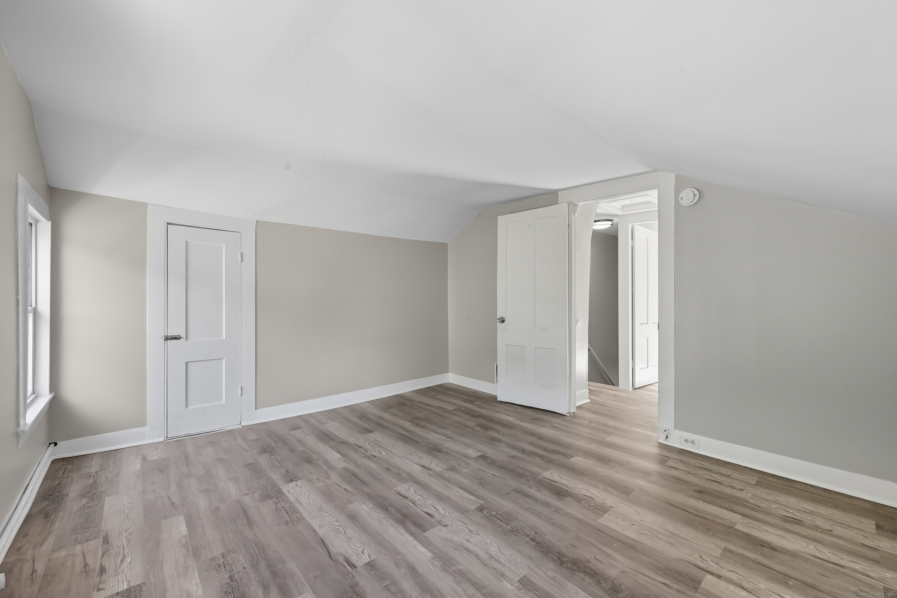 785 Main Street Plymouth, CT 06782 - Photo 20 of 30 a view of an empty room with wooden floor and window
