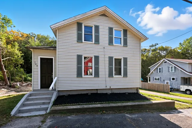 a front view of a house with a yard