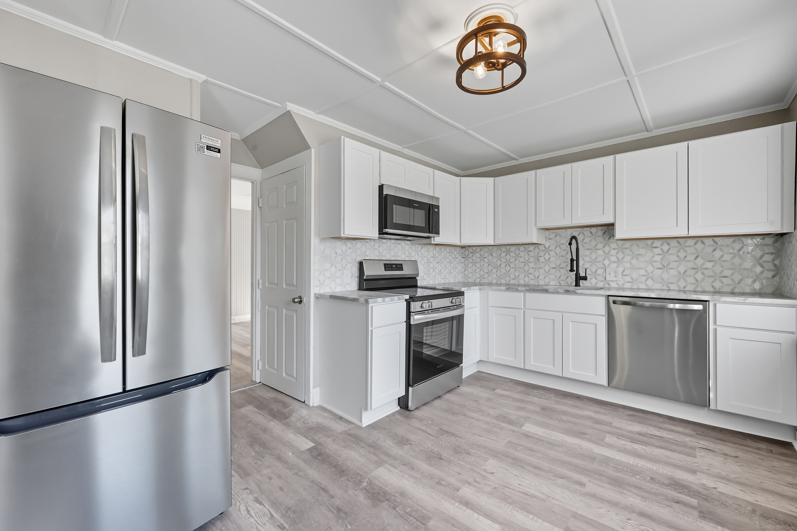785 Main Street Plymouth, CT 06782 - Photo 4 of 30 a kitchen with a refrigerator and a stove top oven