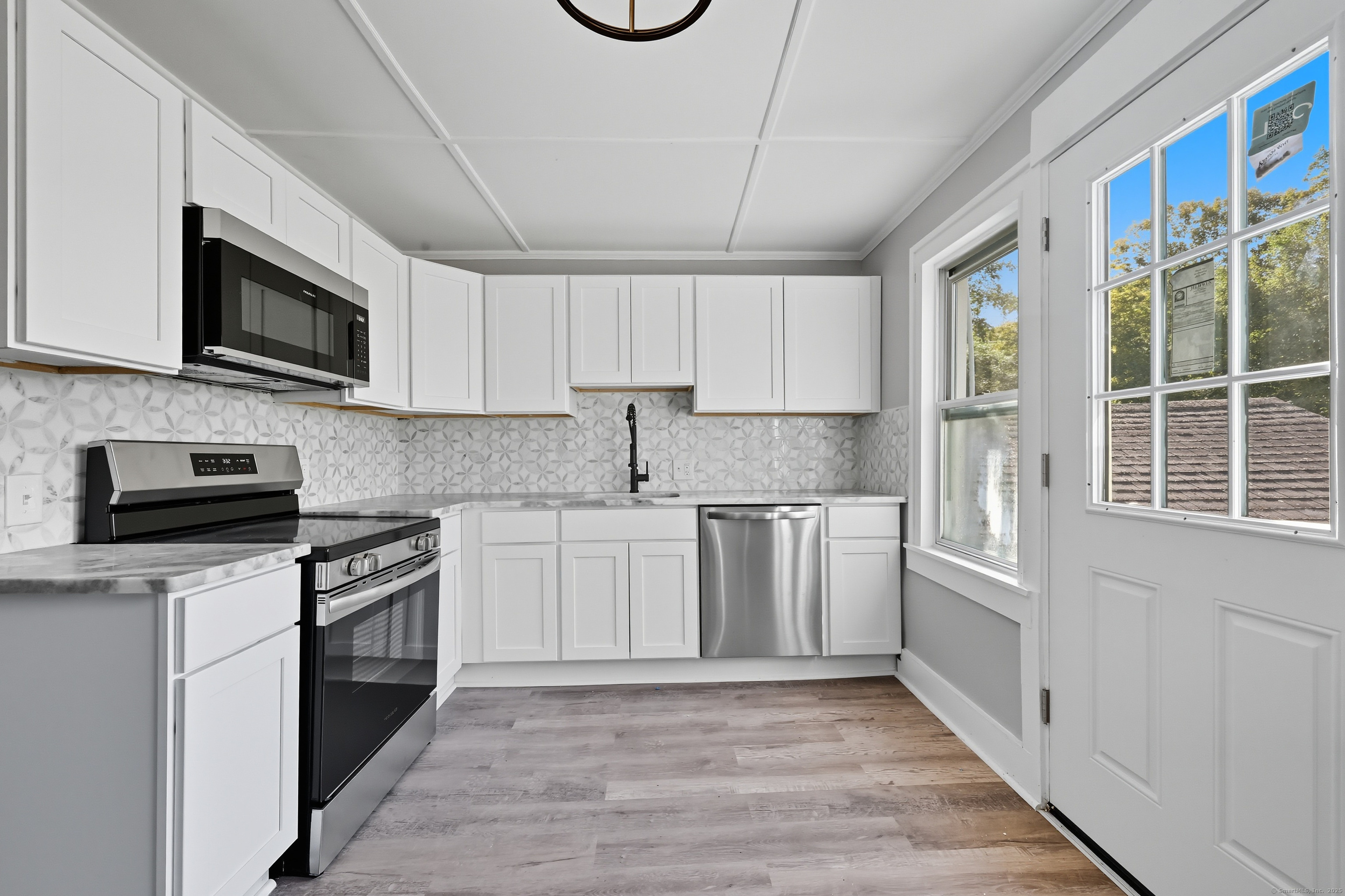 785 Main Street Plymouth, CT 06782 - Photo 5 of 30 a kitchen with stainless steel appliances granite countertop a stove and a microwave