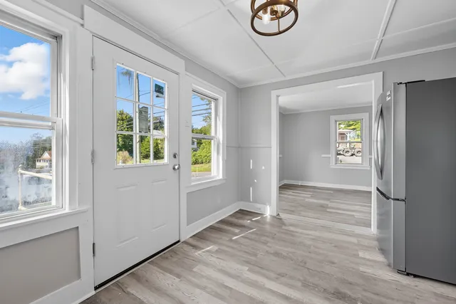 a view of entryway with window and wooden floor