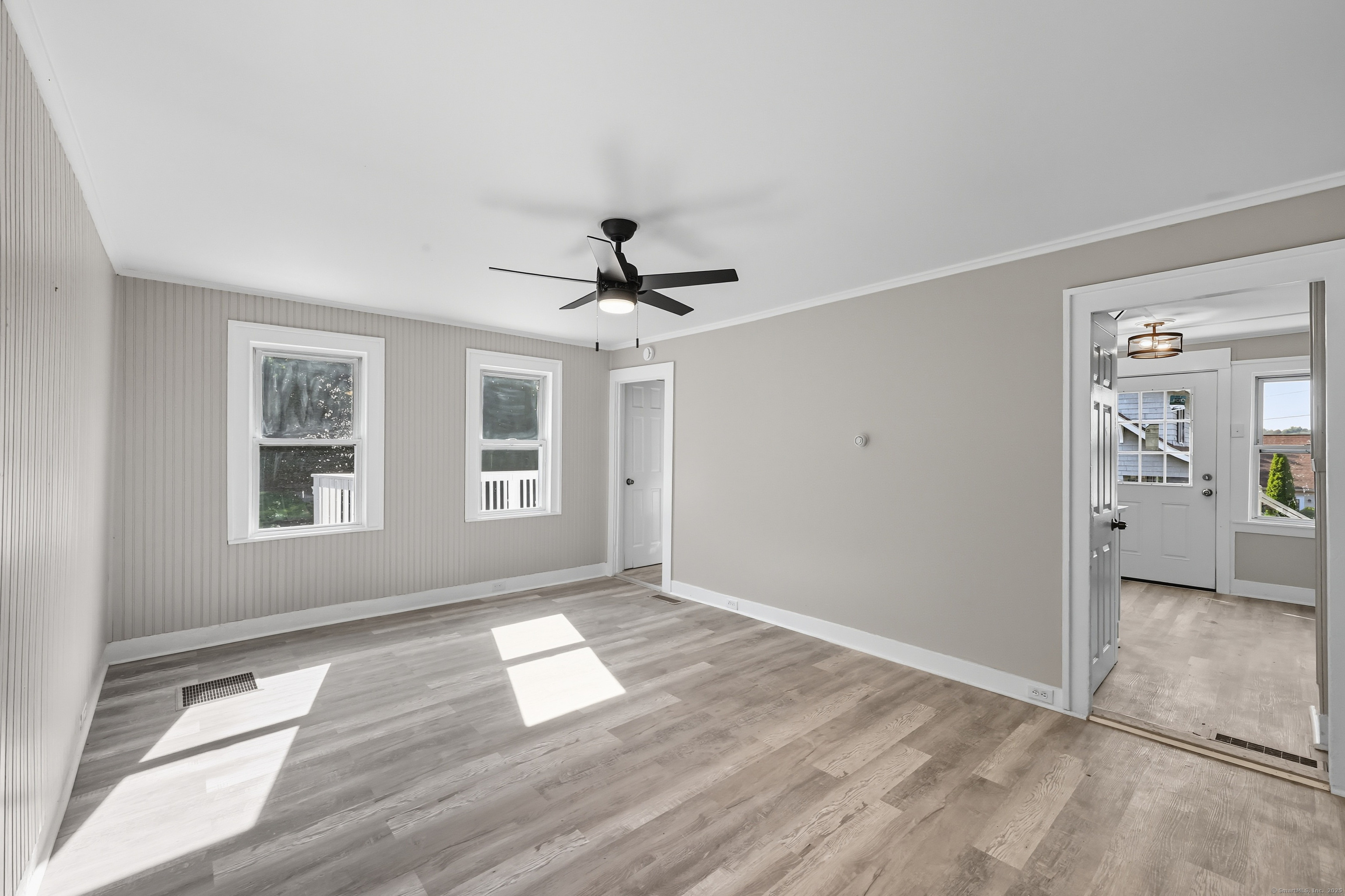 785 Main Street Plymouth, CT 06782 - Photo 9 of 30 a view of empty room with wooden floor and fan