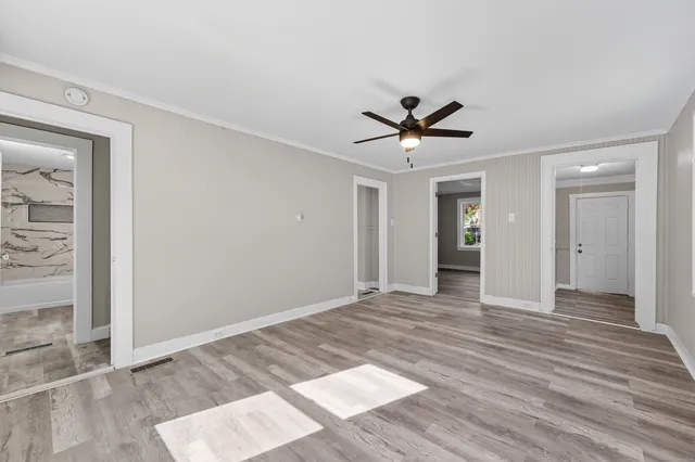 wooden floor in an empty room with a window