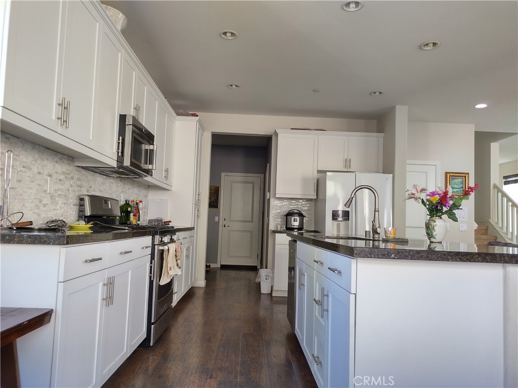 11811 Cramer Road Yucaipa, CA 92399 - Photo 16 of 56 a kitchen with stainless steel appliances granite countertop a sink and cabinets