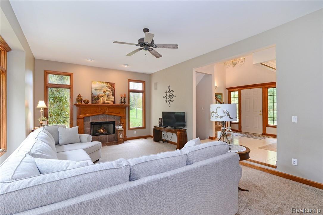 571 Timber Ridge Trail Howell, MI 48843 - Photo 8 of 38 Step down great room with gas fireplace and oak mantel