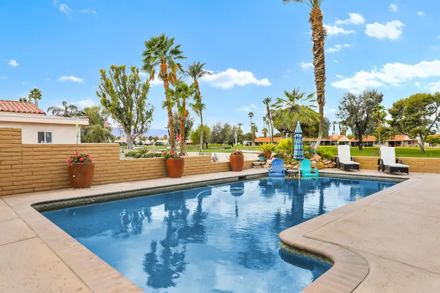 a view of a swimming pool with outdoor seating