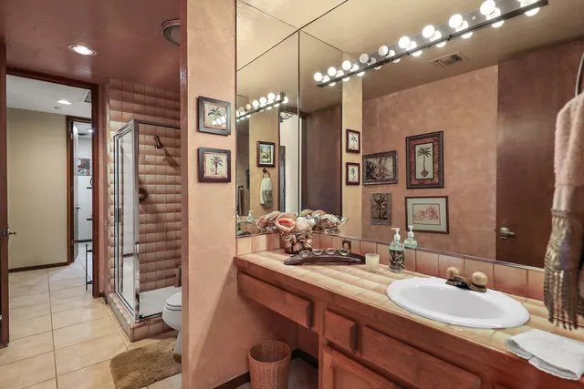 a bathroom with a sink vanity granite and a mirror