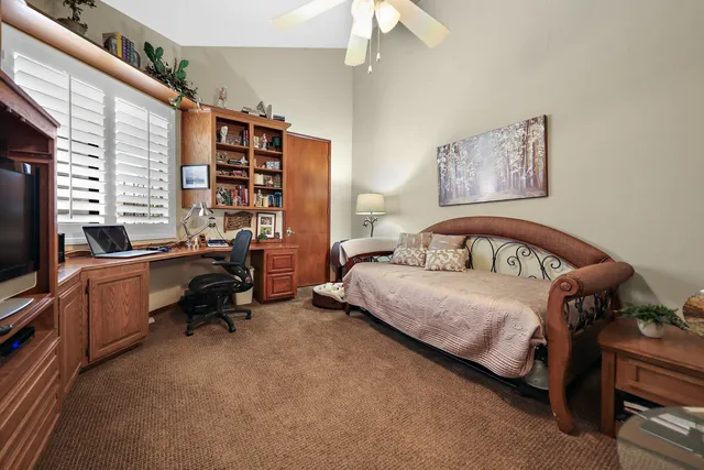 a bedroom with a bed and a desk