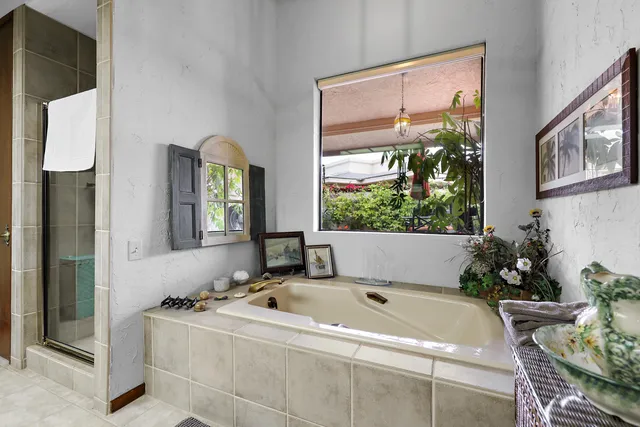 a bed sitting in a living room next to a window