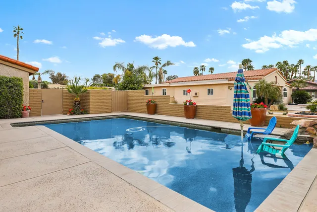 a view of a swimming pool with a lounge chairs