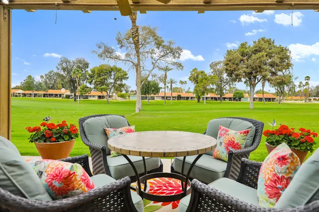 a view of a big yard with furniture and garden