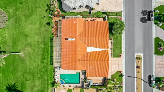 an aerial view of residential houses with outdoor space and trees