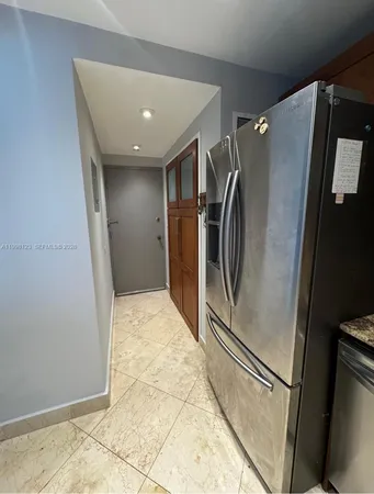 a view of an empty room with closet and mirror