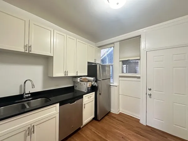 a kitchen with a sink and a stove top oven