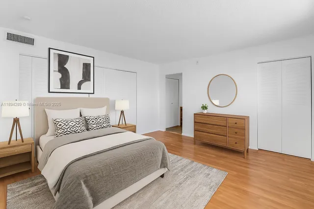 a bedroom with a bed and wooden floor