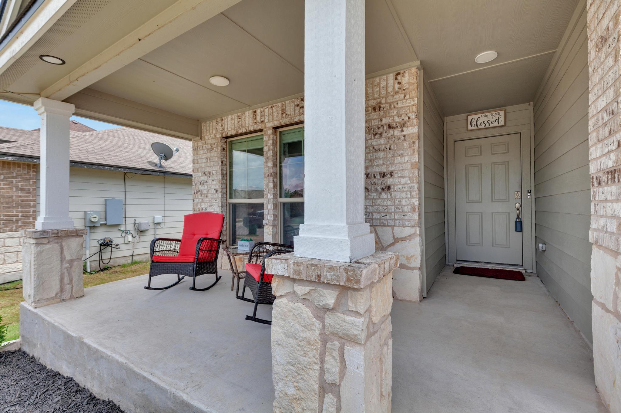 119 Beth Ann Loop Taylor, TX 76574 - Photo 4 of 31 A welcoming front porch features a combination of brick and stone siding.