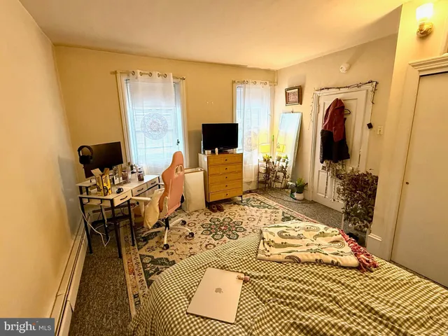 a bedroom with a bed and flat screen tv