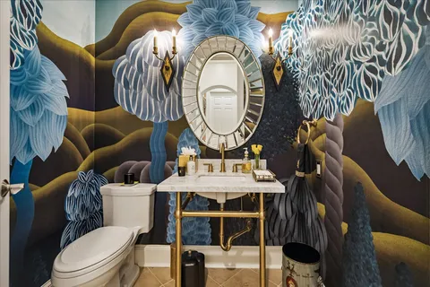 a bathroom with a toilet a sink and a mirror