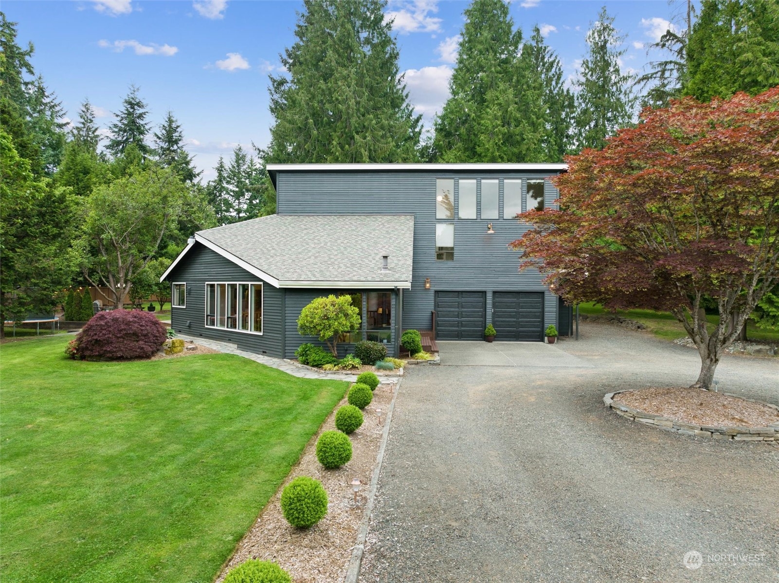 a view of a house with a yard and a patio