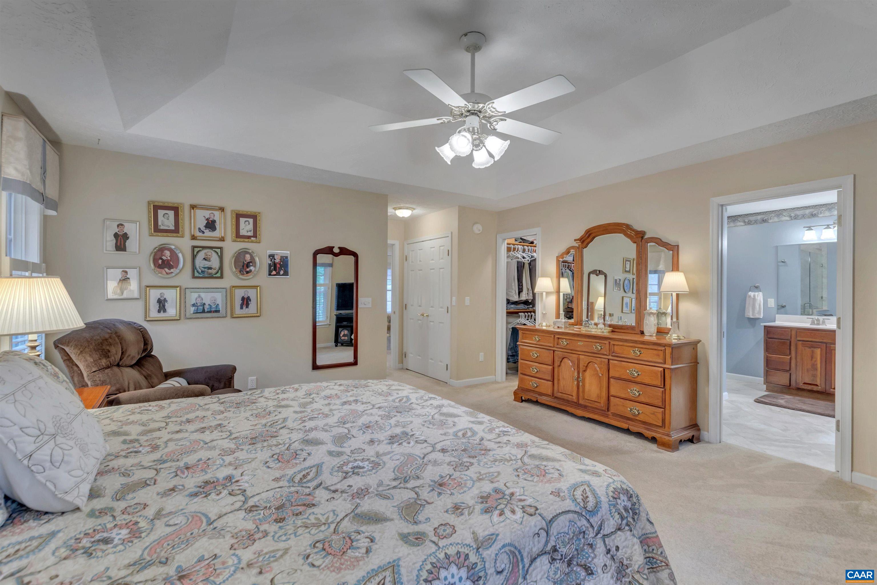 8 Out Of Bounds Road Palmyra, VA 22963 - Photo 44 of 66 a bedroom with a large bed and a chandelier