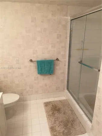 a bathroom with a shower and a toilet